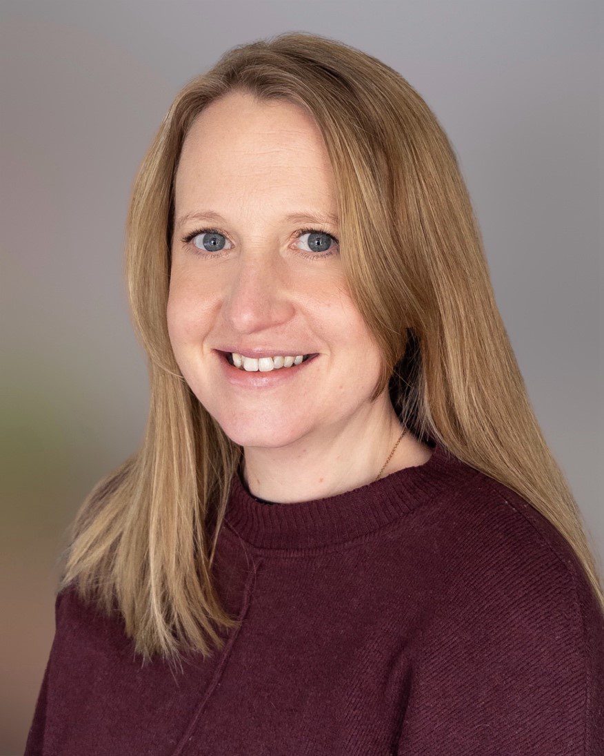 Headshot of Kate McCarthy, wearing a purple top