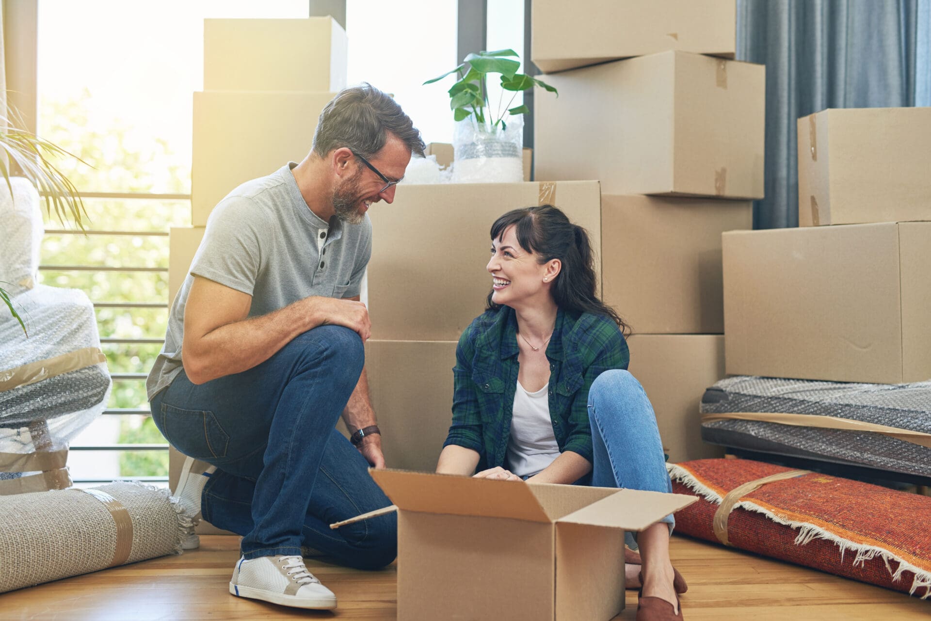Couple moving home with multiple cardboard boxes
