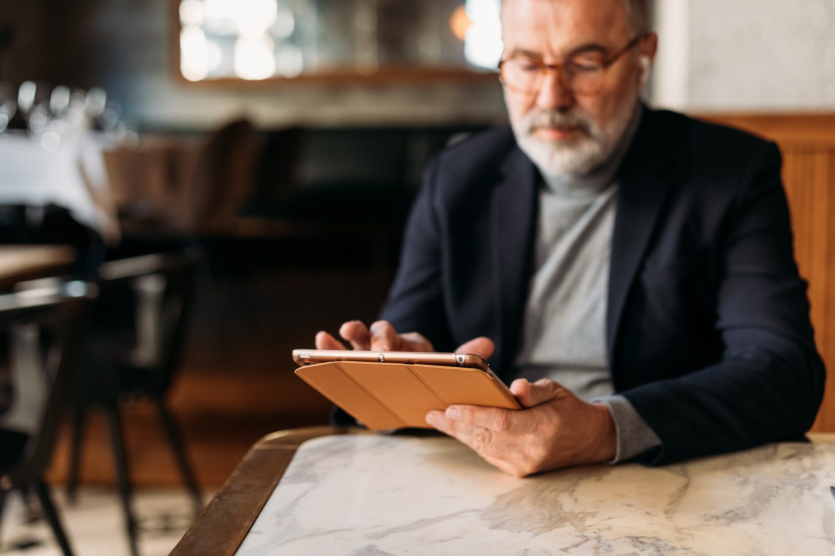 Older gentleman using an iPad to sign his divorce papers