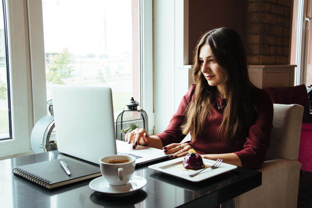 Woman sat with laptop, looking for cheapest ways to get divorced