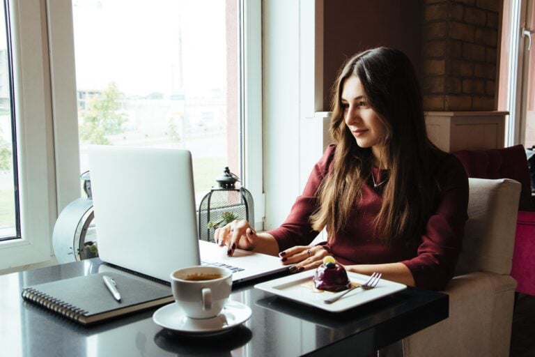 Woman sat with laptop, looking for cheapest ways to get divorced